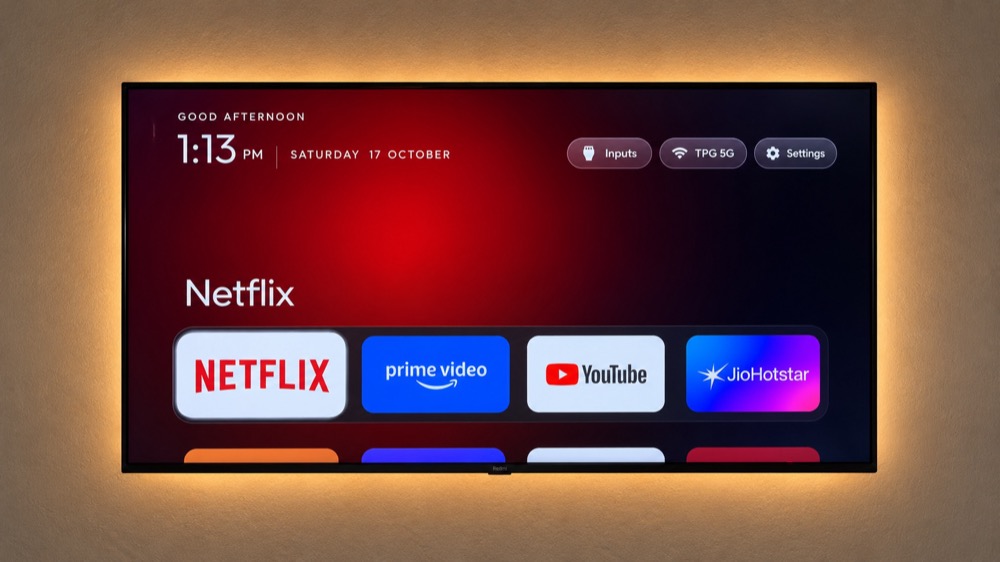 The cleanyourtv launcher home screen with a dock of four apps and an ambient glow